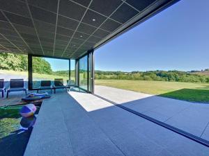 an external view of a house with a patio at Villa Wapiti Small in Aywaille