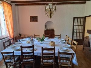 a dining room with a long table with chairs at Gite chez Elisa in Le Fousseret +12 photos