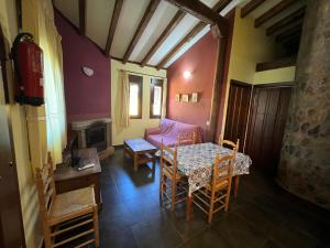 a living room with a table and a couch at La Ondina del Madrigal in Casas del Monte