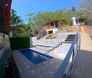 a house with a swimming pool and stairs next to a building at kites mountain in Badulla