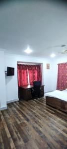 a room with two beds and a desk in it at Greenoriva - Greenery & Peace - Z1 in Srinagar
