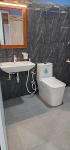 a bathroom with a toilet and a sink at Green star villa in Jaffna +32 photos