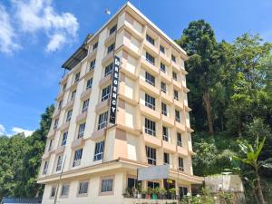 a building with a sign on the side of it at Rare Himalayas De Regency Pelling in Pelling