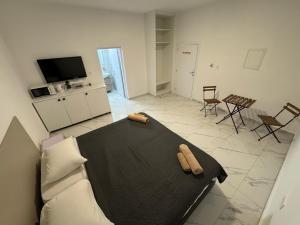 a living room with a bed and a kitchen with chairs at Napa Entry apartments in Ayia Napa