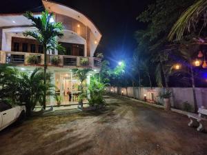 a house at night with palm trees in front of it at Green star villa in Jaffna