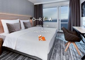 a hotel room with a bed with a ms club free parking at OREA Resort Horizont Šumava in Železná Ruda