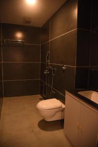 a bathroom with a toilet and a sink at Hotel Urban Heaven in Port Blair +24 photos