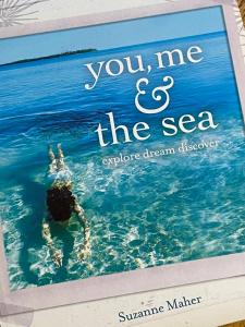 ein Buch mit einer Person, die im Wasser schwimmt in der Unterkunft RIVERBANK COTTAGE in Sussex inlet + 24 Fotos