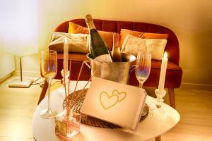 a table with wine glasses and a laptop with a heart on it at Bonbon Love, Gard, Ardèche, Cévennes in Saint-Ambroix