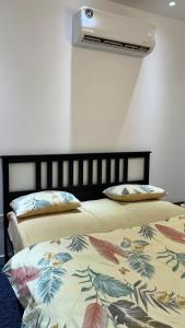 two beds sitting next to each other in a room at Sumeras Sapphire Retreat in Ajman 