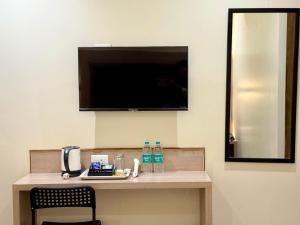 a room with a counter with a tv on the wall at Hotel Riza - Near Nesco Exhibition Centre in Mumbai