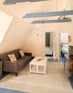 a living room with a couch and a table at 3 Bedroom 2 Bath Carriage House (Pet Friendly) in Bar Harbor +14 photos