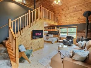 a living room with a staircase and a living room with a couch at Cabin in Ellicottville, Fire Place & Hot Tub in West Valley +49 photos