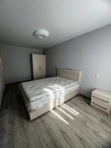 a bedroom with a bed and a dresser in it at sky in Kutaisi