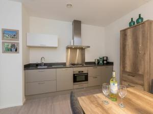 a kitchen with a table with two wine glasses on it at Holiday Home in Koudekerke near the Beach in Koudekerke