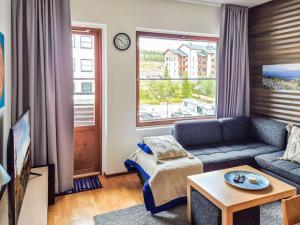 a living room with a couch and a table at Holiday Home Nordic chalet 9408 by Interhome in Ylläs