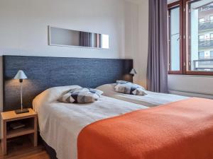 a bedroom with two beds and a large window at Holiday Home Nordic chalet 9408 by Interhome in Ylläs +9 photos