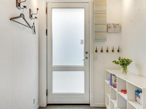 a white door with a window in a room at Holiday Home Sverkel - 700m from the sea by Interhome in Hornbæk