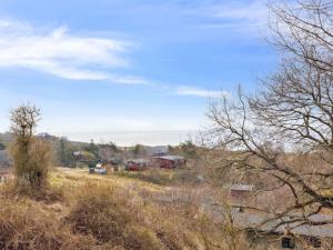a view of a field with trees and buildings at Holiday Home Bondi - 150m from the sea by Interhome in Åkirkeby