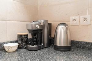 a coffee maker sitting on top of a counter at La Brise de Merkala - Appartement spacieux avec Balcon - 5' à pied de la plage de Merkala et de la Corniche - WIFI et IPTV in Tangier