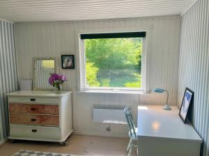 a room with a dresser and a window and a desk at Holiday Home Eragon - 1-2km from the sea by Interhome in Gilleleje