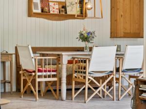 a dining room table with four chairs around it at Holiday Home Lasse - 1-5km from the sea by Interhome in Græsted +19 photos