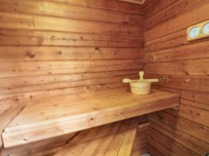 a wooden sauna with a bucket on a shelf at Holiday Home Nikolce - 250m from the sea by Interhome in Rønne