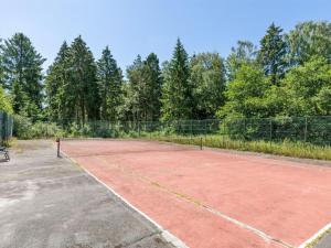 a tennis court with a bench on it at Apartment Melita - 300m from the sea by Interhome in Neksø