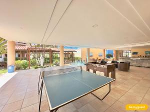 a ping pong table in the middle of a room at Vila do Mar - Porto das Dunas in Aquiraz