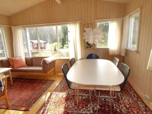 ein Wohnzimmer mit Tisch und Couch in der Unterkunft Holiday Home Hannele - 200m from the sea by Interhome in Svaneke