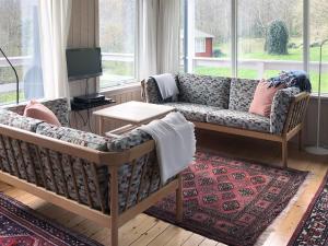 ein Wohnzimmer mit Sofa und Tisch in der Unterkunft Holiday Home Hannele - 200m from the sea by Interhome in Svaneke