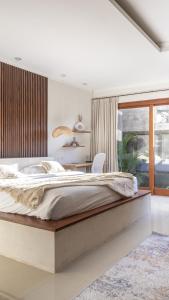 a bedroom with a large bed and a desk at Designer Studio Emy Sanur in Sanur