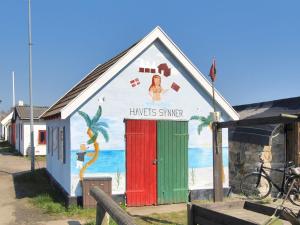 a building with a painting on the side of it at Holiday Home Ignat - 175m from the sea by Interhome in Neksø