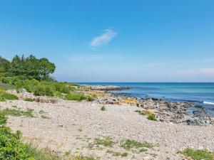 a rocky beach with the ocean in the background at Apartment Gjuro - 50m from the sea by Interhome in Allinge