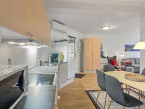 a kitchen and dining room with a table and chairs at Apartment Gjuro - 50m from the sea by Interhome in Allinge +9 photos