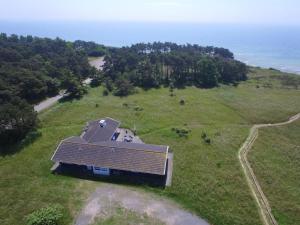 an aerial view of a house in a field with the ocean at Holiday Home Kajsa - 50m from the sea by Interhome in Vester Sømarken