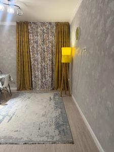 a living room with a large window and a rug at Жк Райымбек in Almaty +14 photos