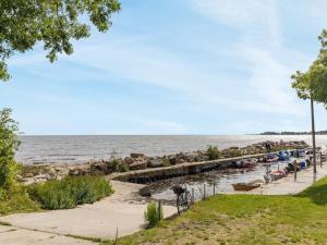 a row of boats in the water next to a dock at Holiday Home Julietta - 50m from the sea by Interhome in Neksø