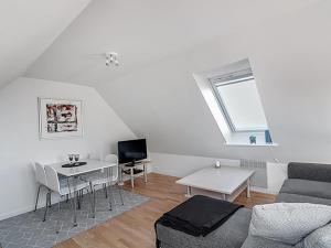 a living room with a couch and a table at Apartment Sylviane - 500m from the sea by Interhome in Gudhjem