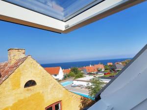 a book on top of a building with the ocean in the background at Apartment Sylviane - 500m from the sea by Interhome in Gudhjem