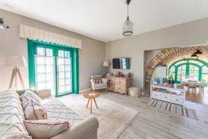 a living room with a couch and a table at Herczeg-Fekete Cottage Birtokközpont in Simontornya