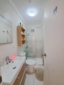 a bathroom with a shower and a toilet and a sink at Pensiòn Cerdà 112 in Alicante +26 photos