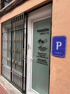 a sign on the door of a restaurant with a spider on it at Pensiòn Cerdà 112 in Alicante