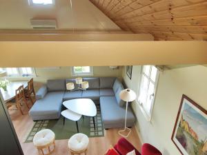 a living room with a couch and a table at Holiday Home Spurgh - 250m from the sea by Interhome in Allinge