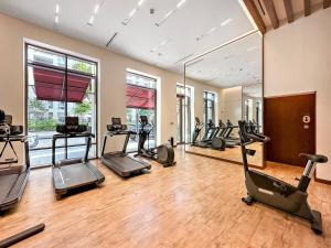 a gym with several treadmills and elliptical machines at FIRST CLAS 1BR Creek Beach , Lagoon Access in Dubai