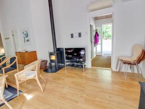 a living room with a fireplace and chairs at Holiday Home Dilan - 600m from the sea by Interhome in Hasle