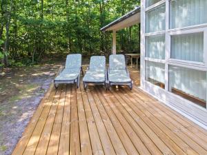 two chairs sitting on a deck next to a house at Holiday Home Dilan - 600m from the sea by Interhome in Hasle