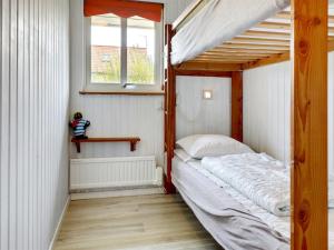 a small bedroom with a bunk bed and a window at Holiday Home Voitto - 150m from the sea by Interhome in Allinge +16 photos
