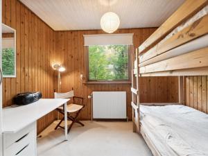 a bedroom with a bunk bed and a desk at Holiday Home Joske - 250m from the sea by Interhome in Hasle