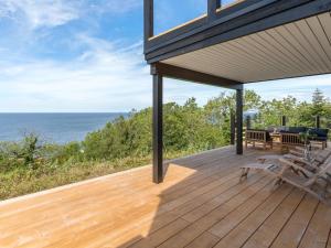 a wooden deck with a view of the ocean at Holiday Home Thormoth - 200m from the sea by Interhome in Hasle
